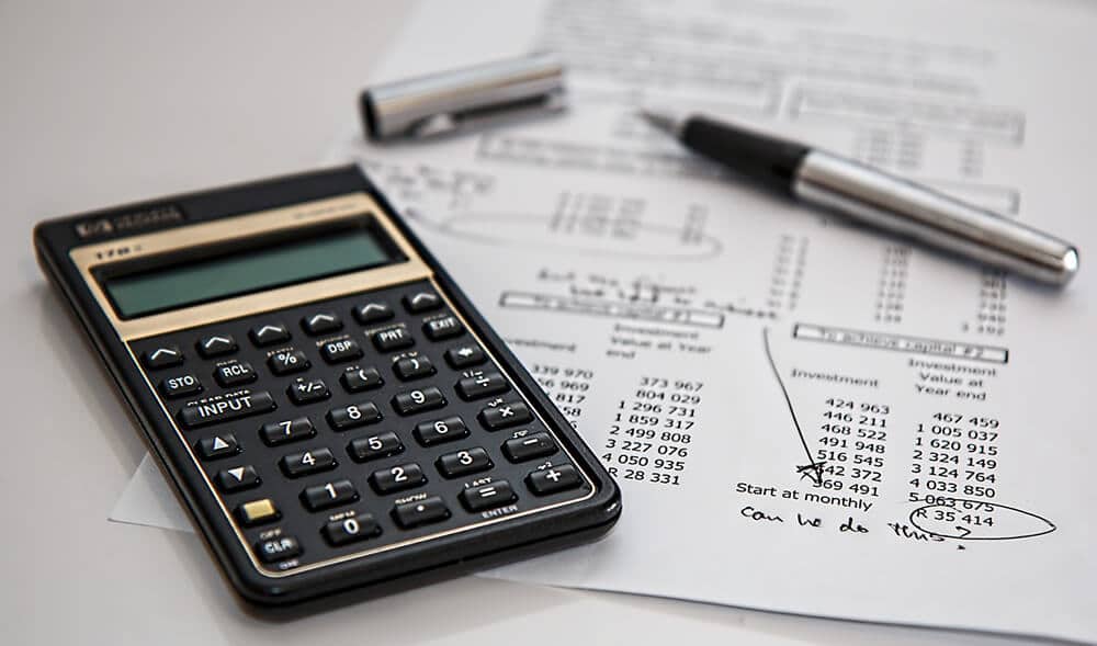 Calculator and pen on top of worksheet 