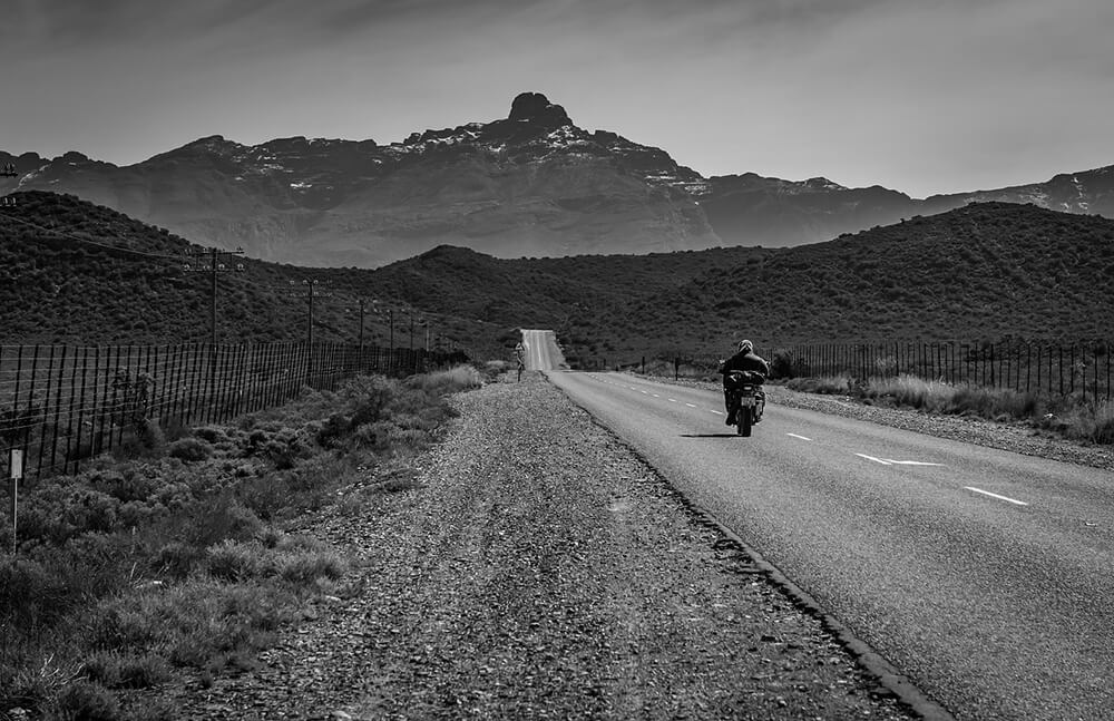 man riding motorcycle on road